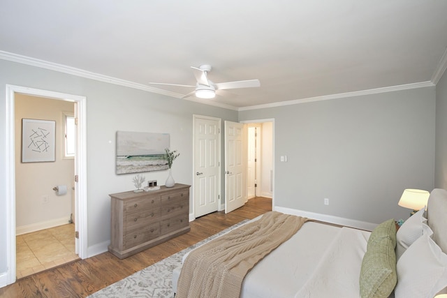 bedroom with hardwood / wood-style floors, ensuite bath, ornamental molding, and ceiling fan