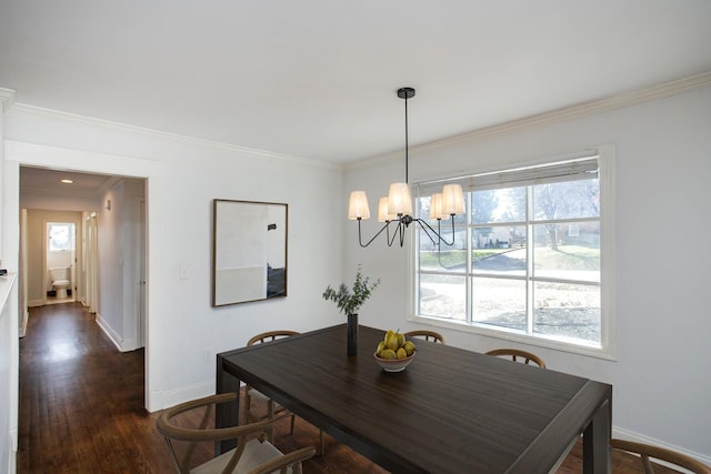 dining area featuring a notable chandelier, ornamental molding, and dark wood-type flooring