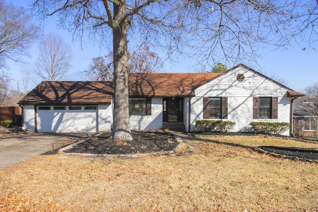 ranch-style home featuring a garage and a front yard