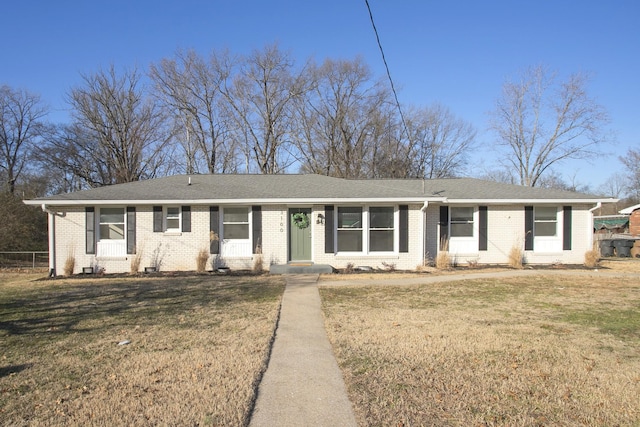 ranch-style home with a front lawn