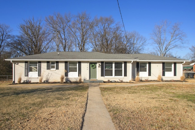 ranch-style home with a front lawn