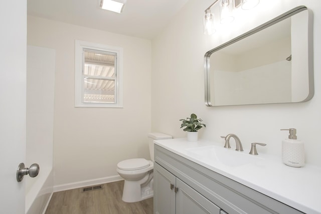 bathroom featuring vanity, hardwood / wood-style floors, and toilet