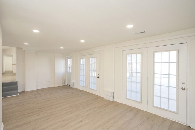 interior space with plenty of natural light and light hardwood / wood-style flooring