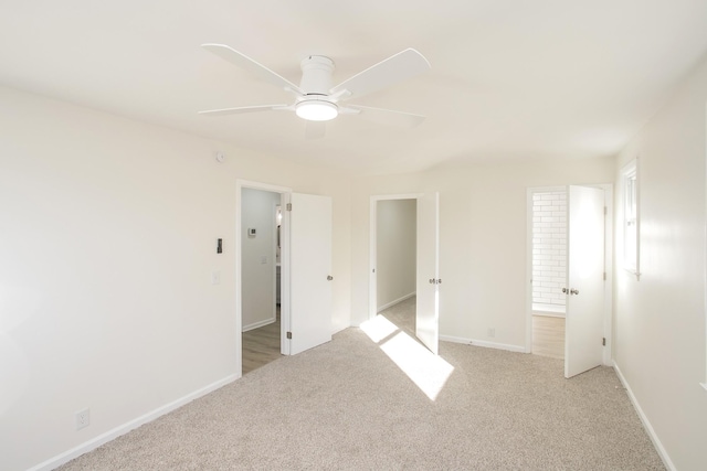 unfurnished bedroom featuring ceiling fan and light colored carpet