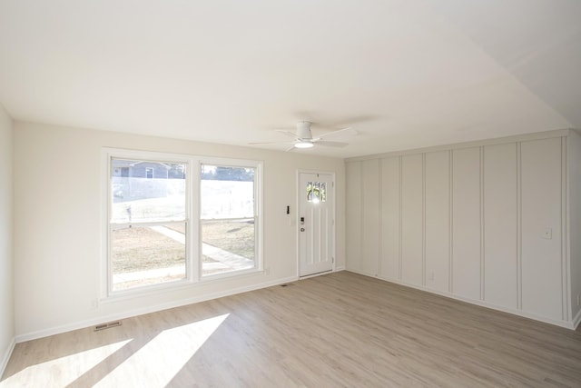 spare room with ceiling fan and light wood-type flooring