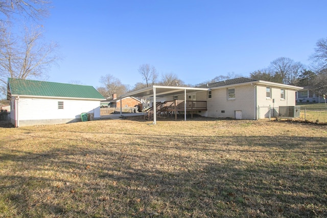 rear view of property with a wooden deck, a yard, and central AC unit