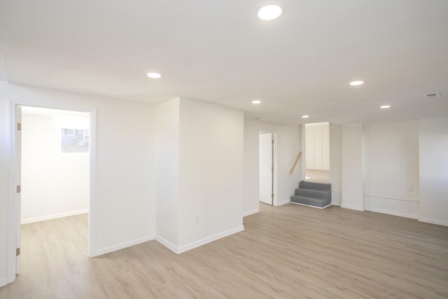 basement with light hardwood / wood-style flooring