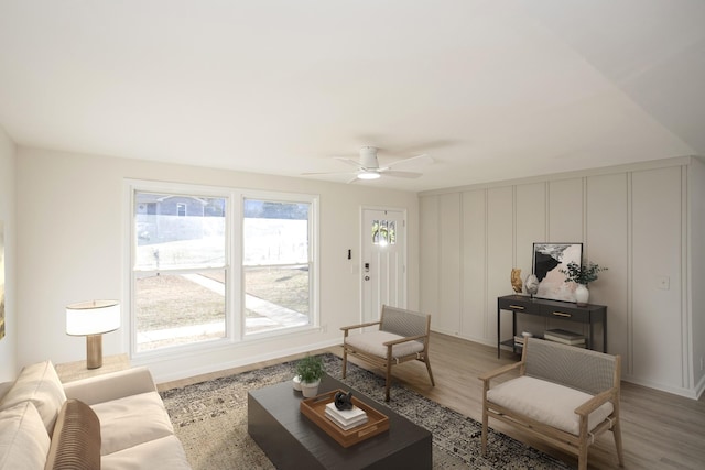 living room featuring hardwood / wood-style floors and ceiling fan