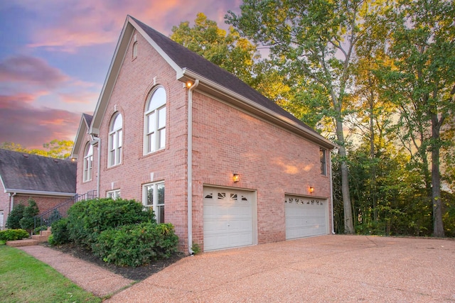 property exterior at dusk featuring a garage