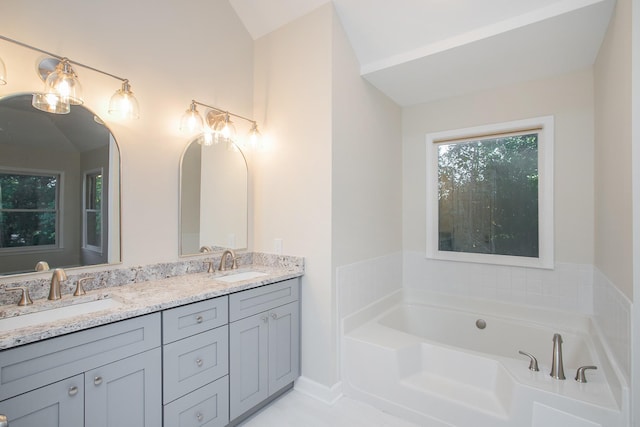 bathroom with a tub to relax in and vanity