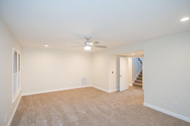 carpeted empty room featuring ceiling fan