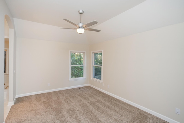 carpeted spare room with ceiling fan