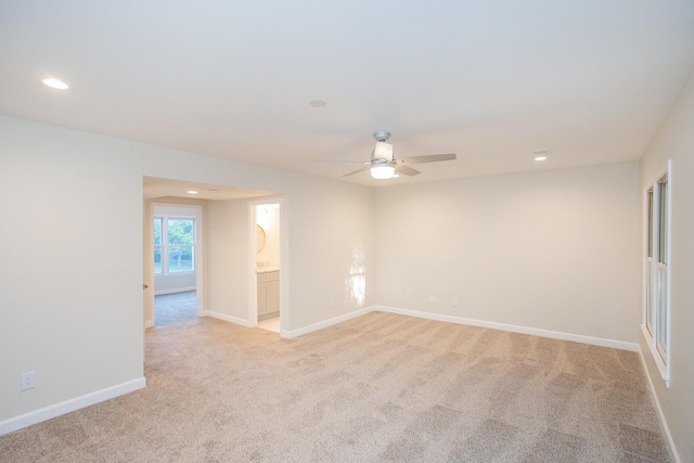 carpeted spare room with ceiling fan