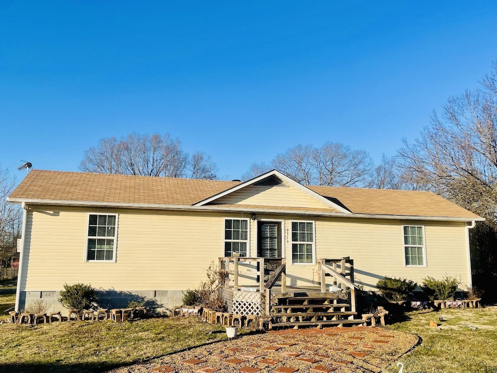 view of front of house featuring a deck and a front lawn