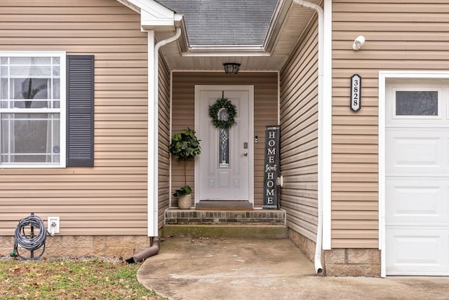 doorway to property with a garage