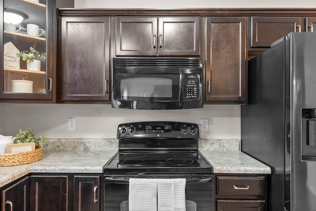 kitchen featuring dark brown cabinets and black appliances