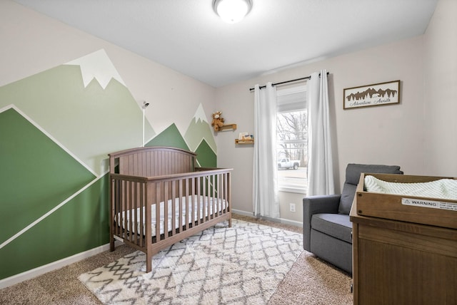 bedroom with a nursery area and carpet