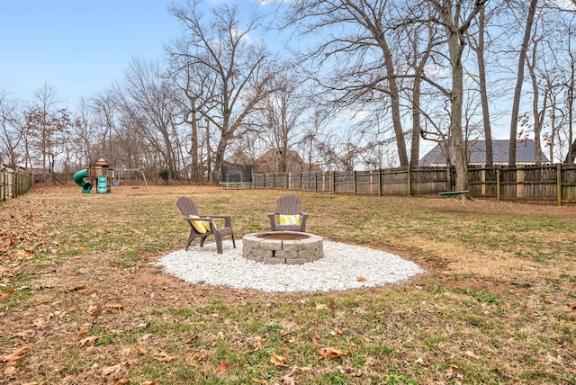 view of yard featuring a fire pit and a playground