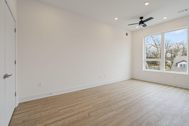 spare room with ceiling fan and light wood-type flooring