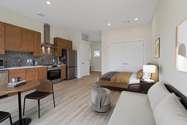 living room with sink and light hardwood / wood-style floors