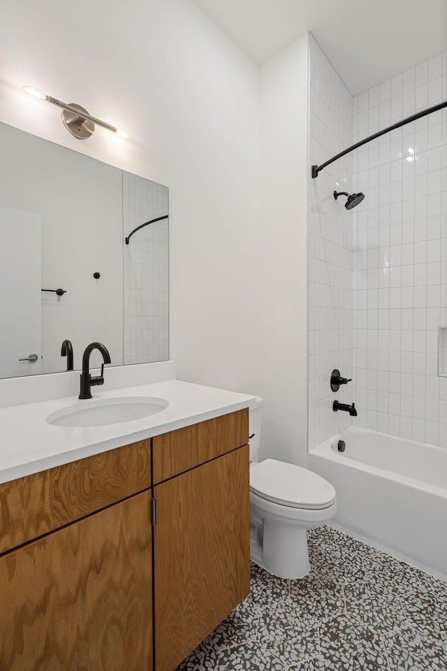 full bathroom featuring vanity, toilet, and tiled shower / bath