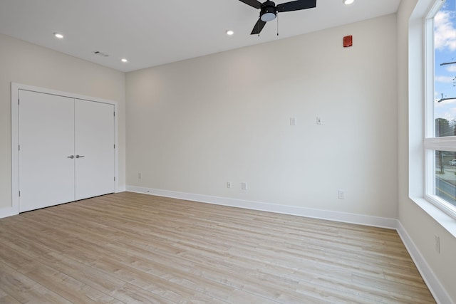 unfurnished bedroom featuring ceiling fan and light wood-type flooring