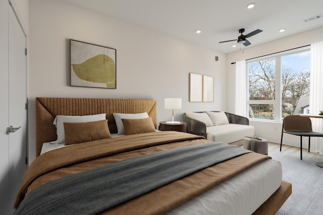 bedroom with ceiling fan and light wood-type flooring