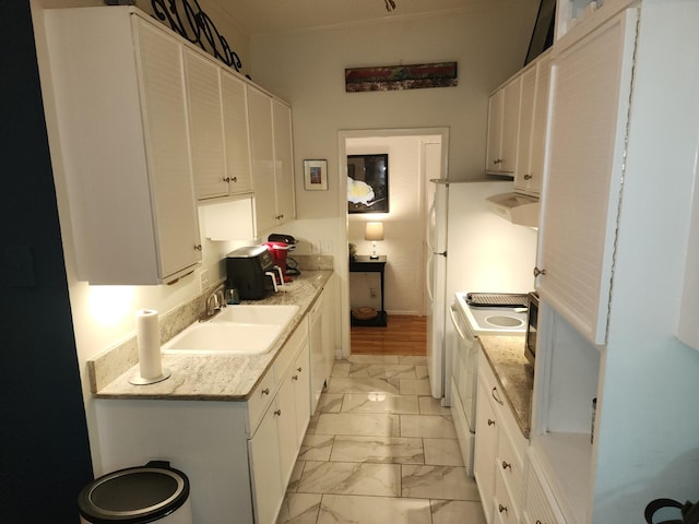 kitchen with light stone countertops, sink, white cabinets, and white appliances