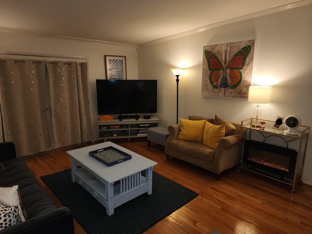 living room featuring crown molding and wood-type flooring