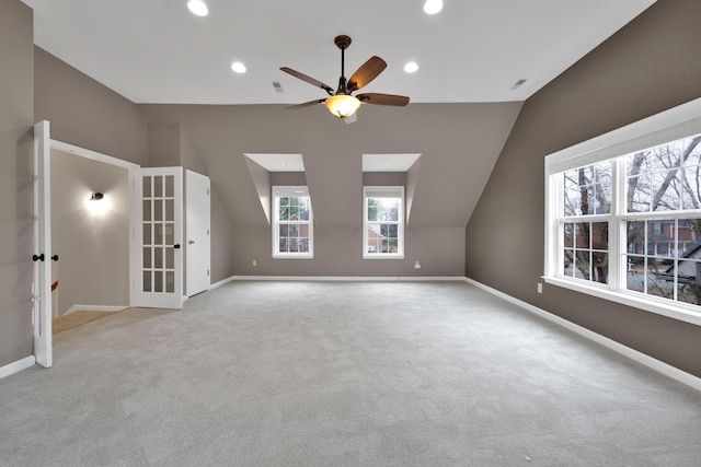 additional living space featuring lofted ceiling, light colored carpet, and ceiling fan