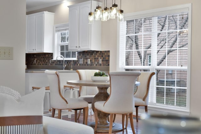 dining room with ornamental molding, a chandelier, and hardwood / wood-style floors