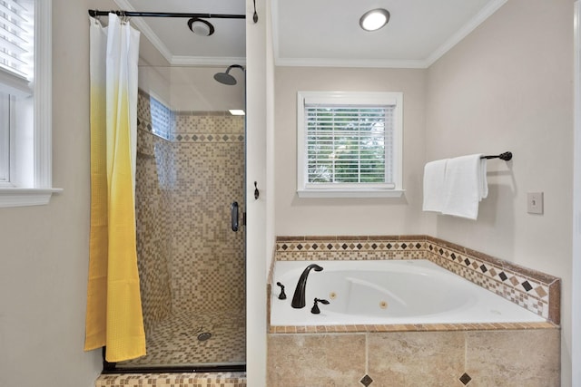 bathroom with ornamental molding and shower with separate bathtub