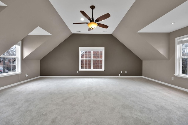 additional living space with vaulted ceiling, carpet floors, and ceiling fan