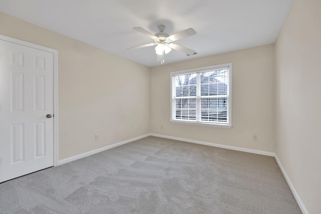 unfurnished room with light colored carpet and ceiling fan