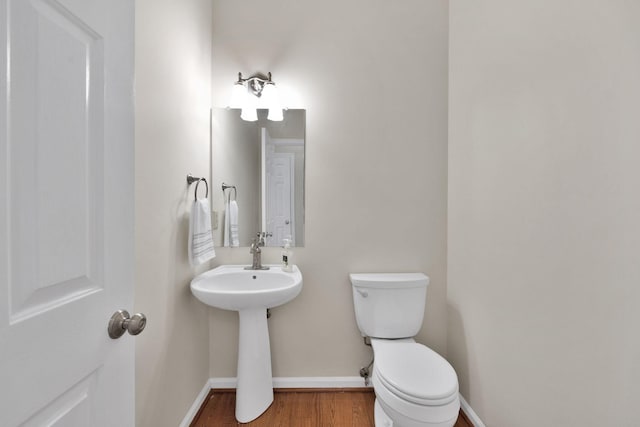 bathroom with wood-type flooring and toilet