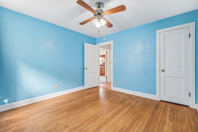 unfurnished bedroom with ceiling fan and light wood-type flooring