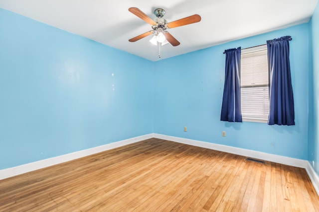 spare room featuring hardwood / wood-style flooring and ceiling fan