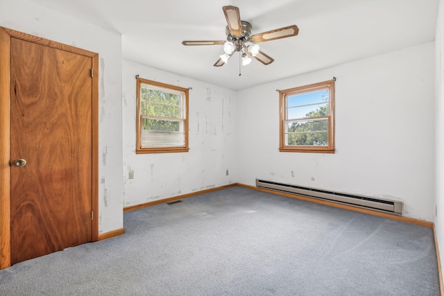 spare room with a wealth of natural light, a baseboard radiator, ceiling fan, and carpet