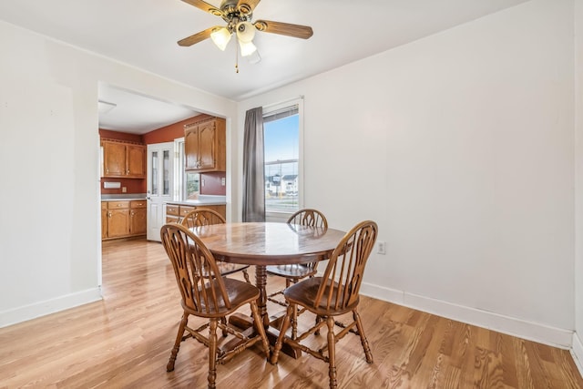 dining space featuring ceiling fan and light hardwood / wood-style flooring