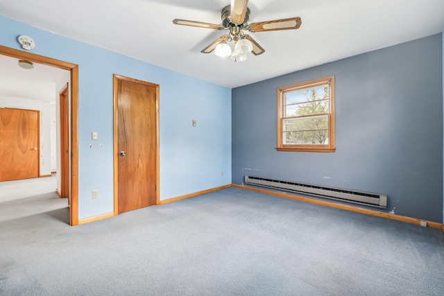 carpeted empty room featuring baseboard heating and ceiling fan