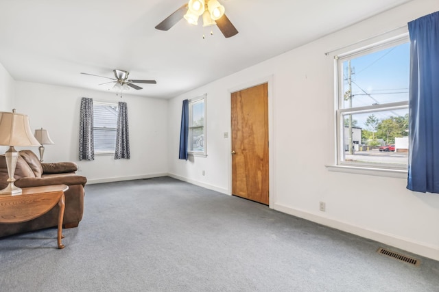 living area with carpet floors and ceiling fan