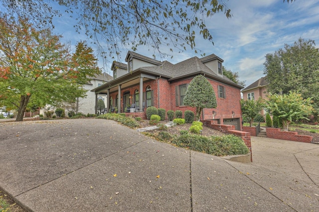 view of front of property featuring a garage and covered porch