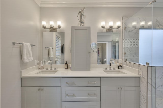 bathroom with crown molding, a sink, a marble finish shower, and double vanity