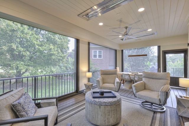 sunroom with wooden ceiling and ceiling fan