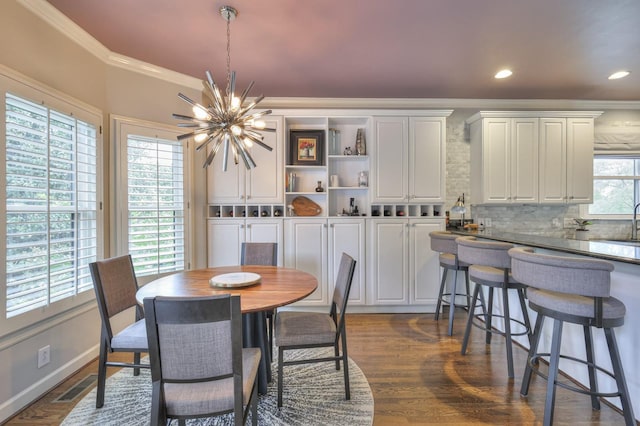 dining area featuring recessed lighting, crown molding, visible vents, dark wood finished floors, and an inviting chandelier