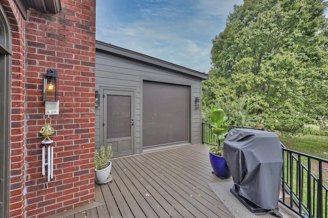 wooden terrace featuring grilling area