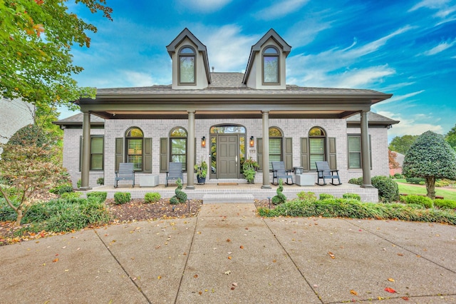 view of front of property with a porch and brick siding