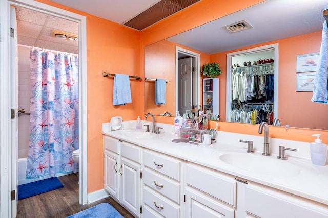 full bathroom with vanity, toilet, wood-type flooring, and shower / bath combo