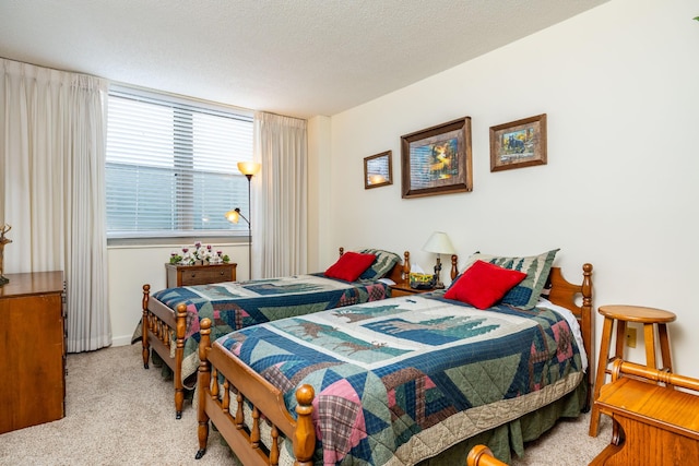 carpeted bedroom featuring a textured ceiling