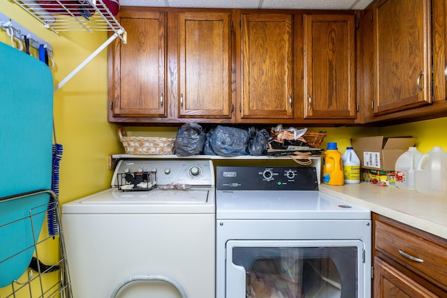 washroom with cabinets and washer and clothes dryer